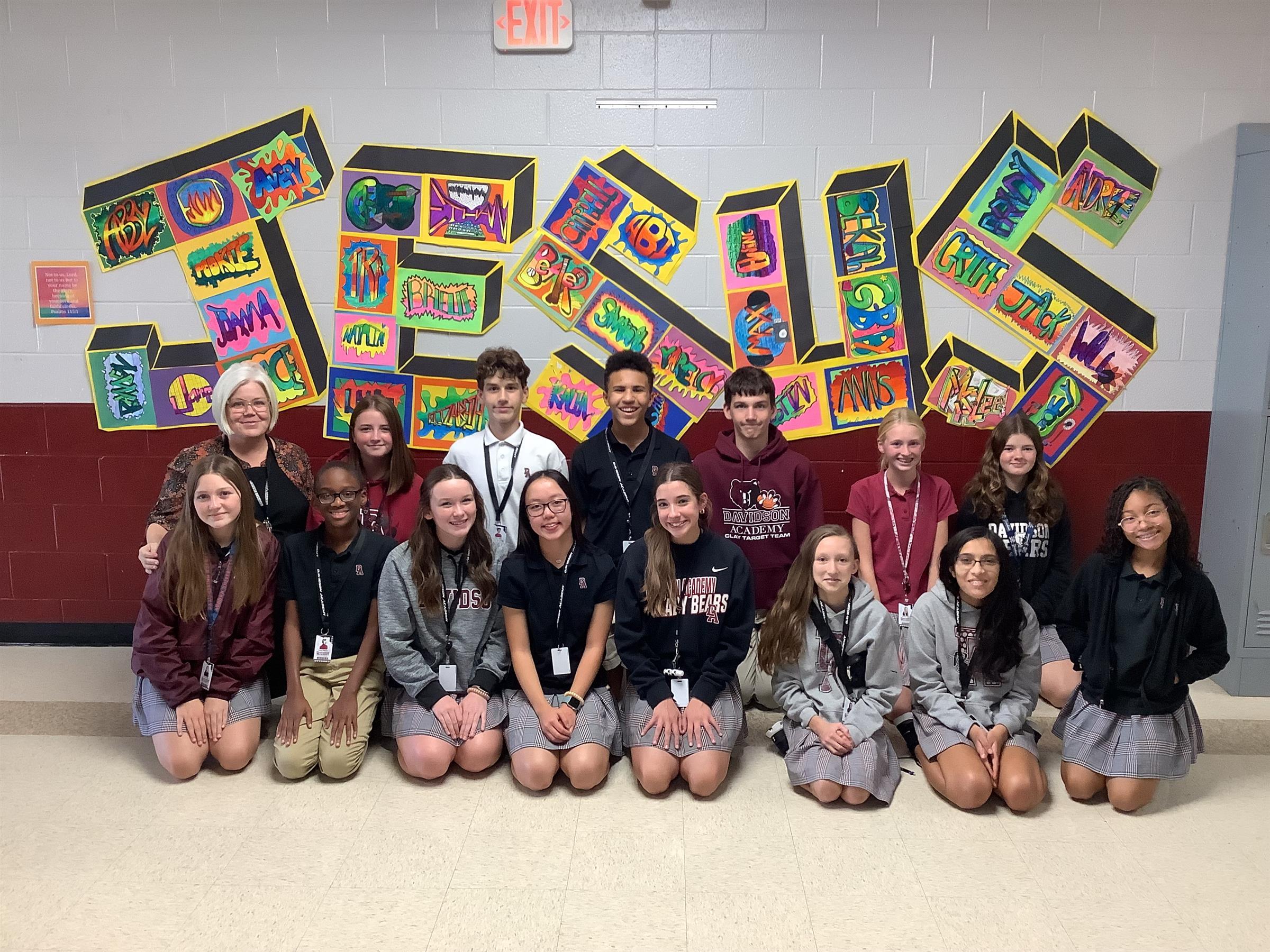 A group of Davidson Academy students in front of an art mural.