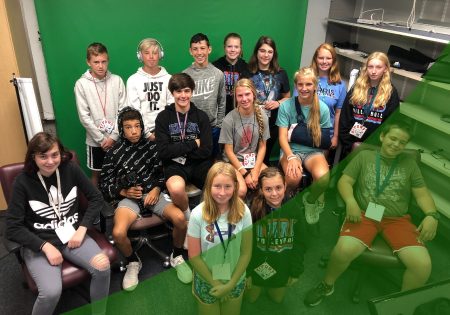 Group of students in front of a green screen in their digital media class