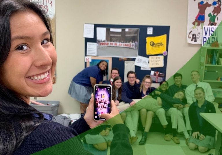 Group of students take a photo in their classroom with a green swoosh lower right corner