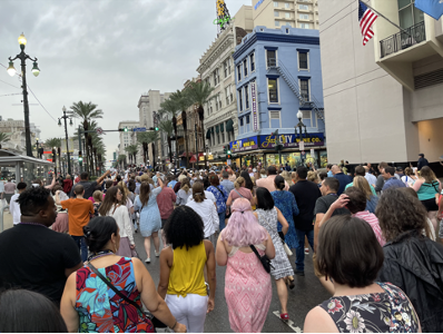 crowd of people in a street in new orleans