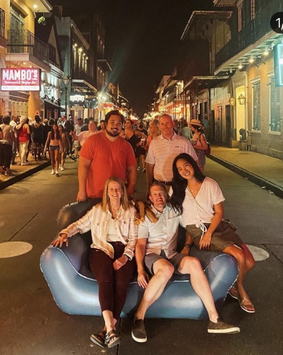 group of people around an inflatable couch in the middle of the street