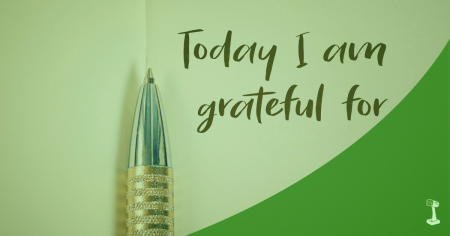 Pen on paper with text, "Today I am grateful for". Green swoosh in the bottom right corner