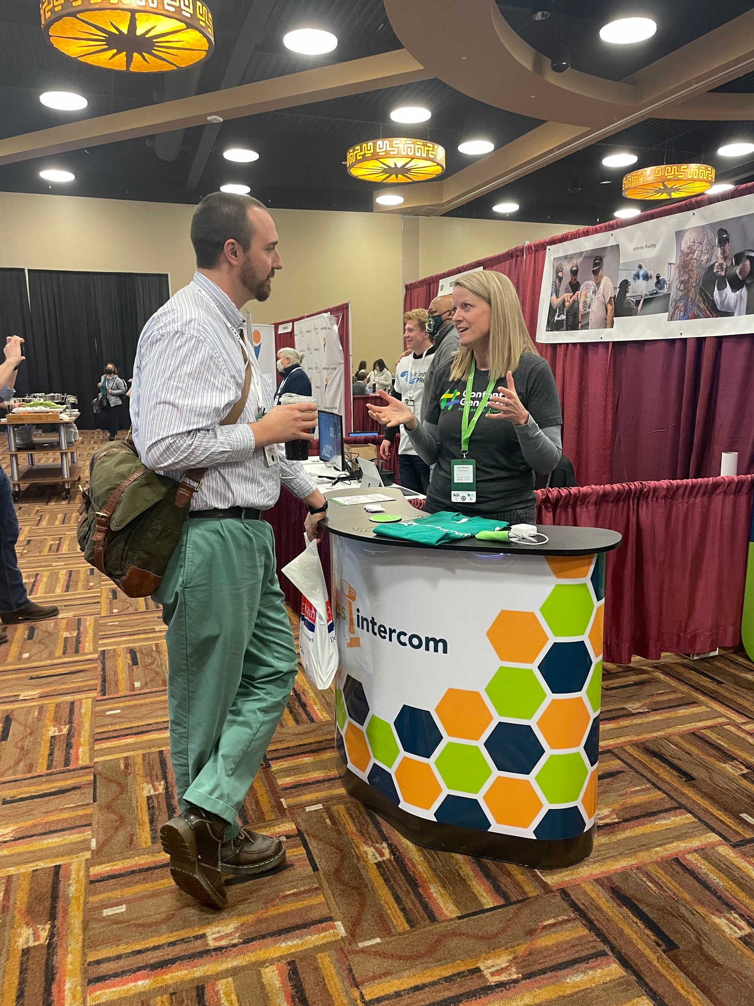 Jill speaking with an educator at a conference booth