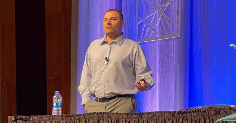 Brandon Mowinkel on stage presenting about school storytelling