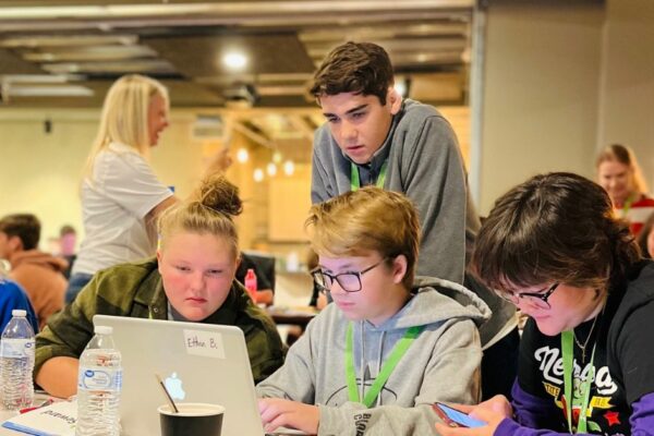 Latest Class Intercom Update Streamlines Posting to Multiple Platforms & Saves Schools Tons of Time Four students collaborating to create content using the Class Intercom platform on a laptop.