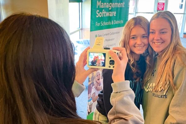 Feature Images Student taking a photo of two smiling high school students