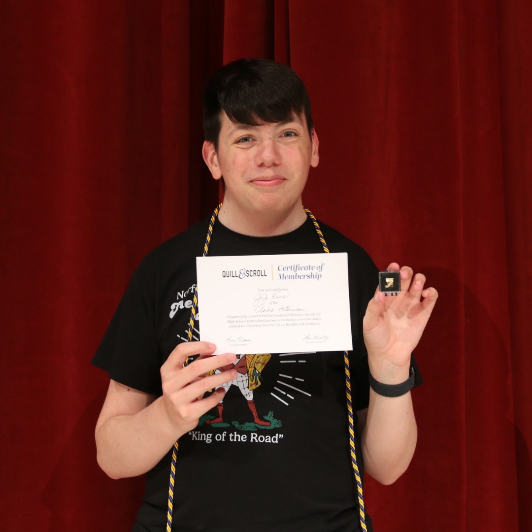 A high school student receiving a reward from Quill and Scroll