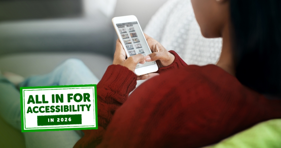 A girl in a red sweater sits on a couch scrolling on her phone. There a graphic overlay that reads, "All in for Accessibility in 2026" almost like a stamp.