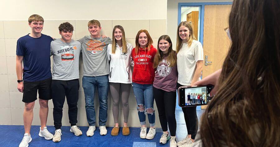 A group of student content creators pose for a picture.