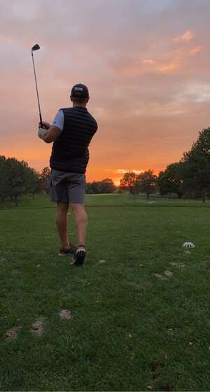 Kalen golfing with friends at sunset, one of the ways he spends his free time outside of training.