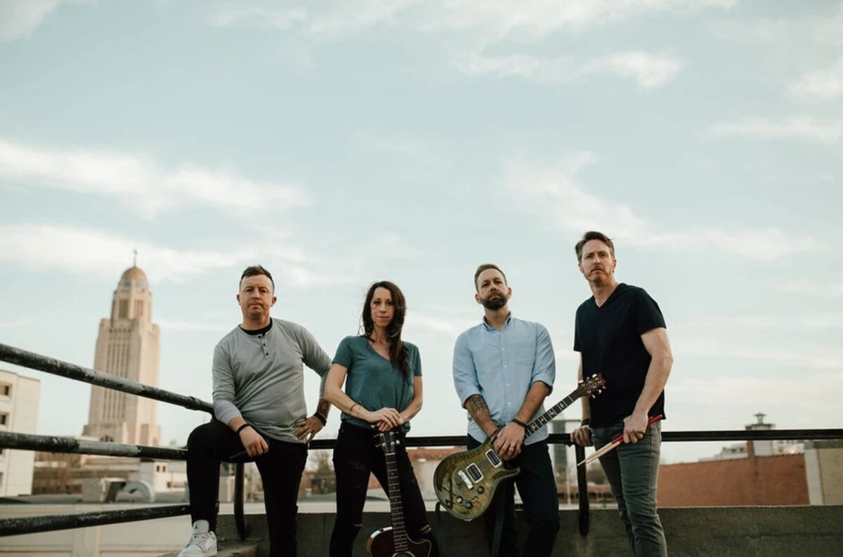 Wonder Rising band standing on a rooftop in downtown Lincoln